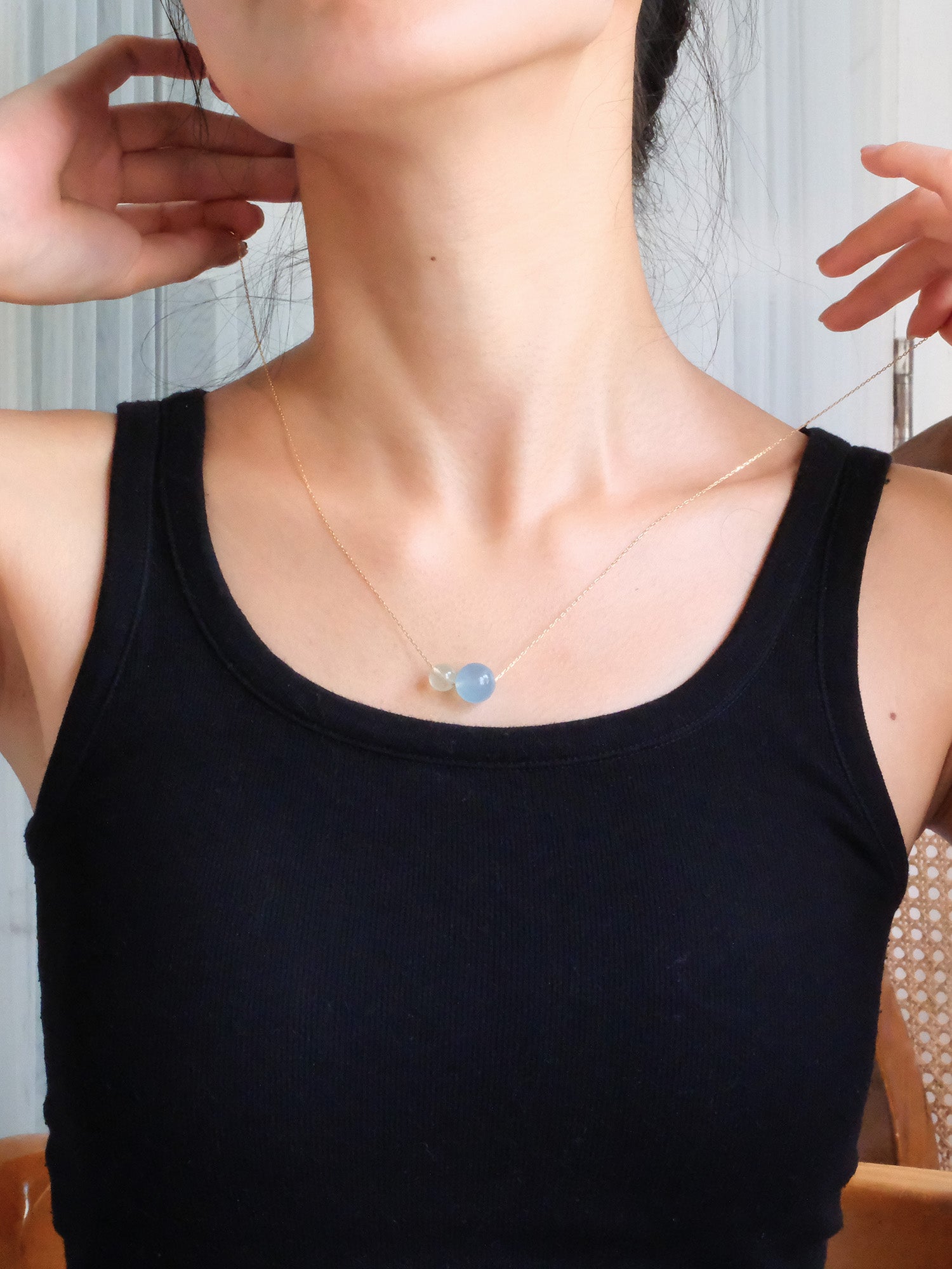 Double Star necklace with green and blue gemstones – soothing crystal design for communication and emotional balance.