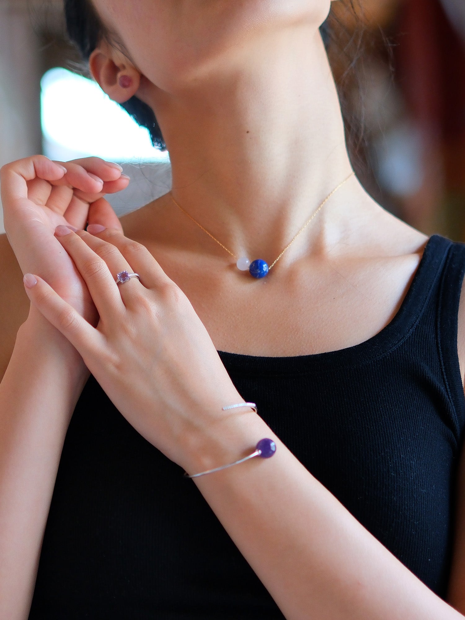 Sterling silver necklace with lapis lazuli and moonstone – mystical design for intuitive clarity and inner wisdom.woman wearing Lapis Lazuli + Moonstone Necklace in gold colour, comet amethyst bracelet and lavender amethyst ring
