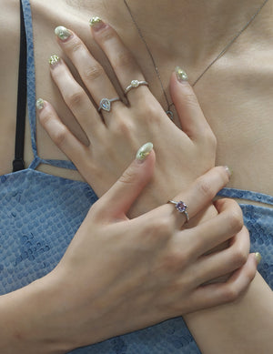 Close-up of hands with silver rings: moonstone, lavender amethyst and pearl. Sterling silver moonstone gemstone ring for protection and harmony in daily commuting