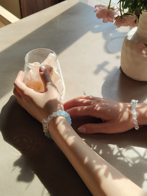 Lifestyle shot of blue crystal bracelet and pink crystal bracelet for spiritual clarity and communication