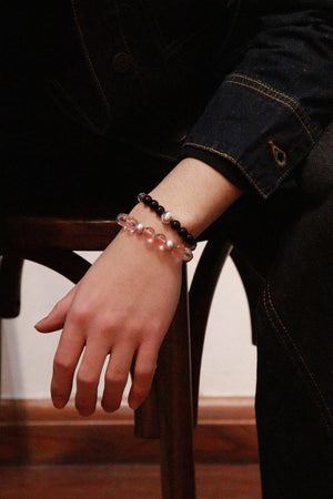 New Moon crystal bracelet worn on wrist, obsidian and clear quartz for a clean, modern look
