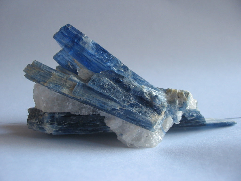 Raw kyanite crystal in deep blue blade-like formations, gemstone of clarity, truth and alignment