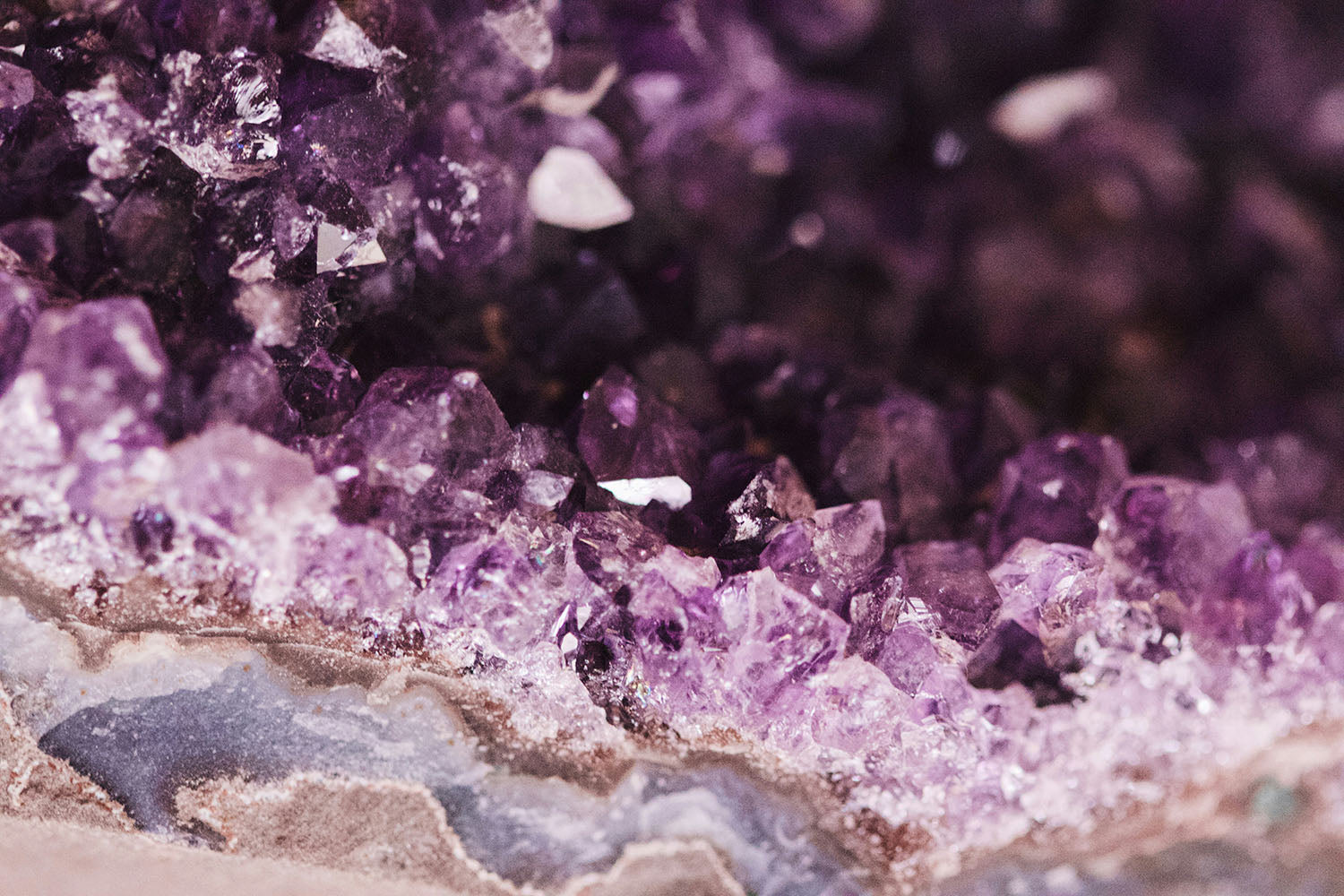 Raw amethyst crystal cluster in vivid purple tones, natural mineral for calm and protection