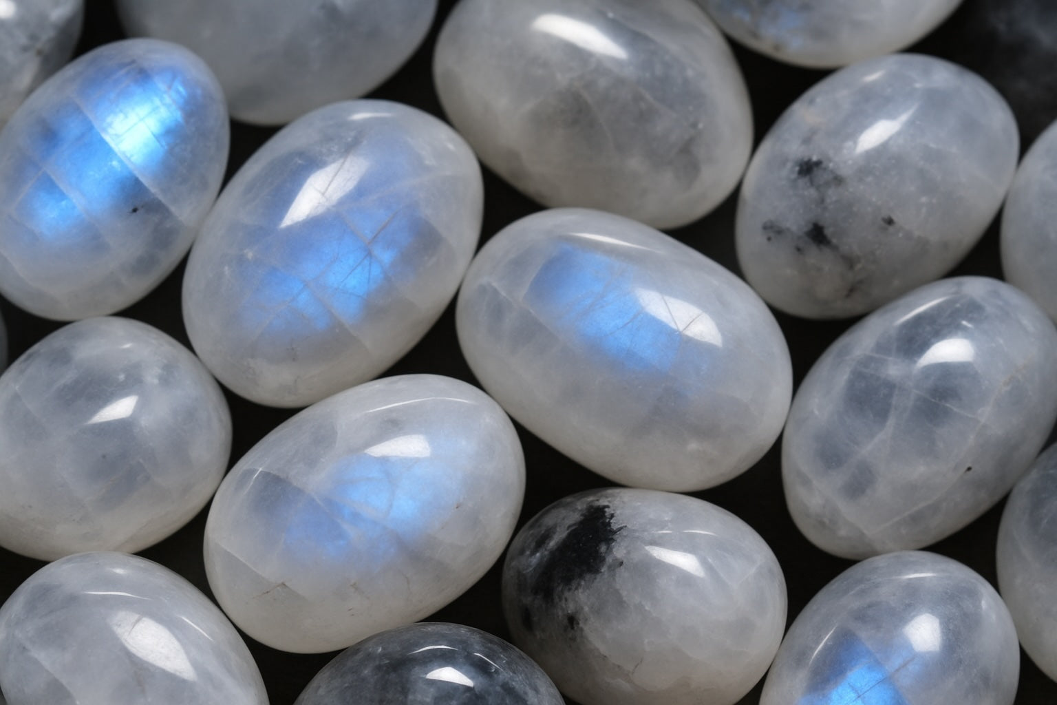 Polished moonstone with glowing blue sheen, oval shape crystal of intuition and new beginnings