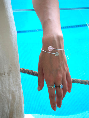 Double Star bracelet with pink and green gemstones – nurturing crystal design for emotional renewal.