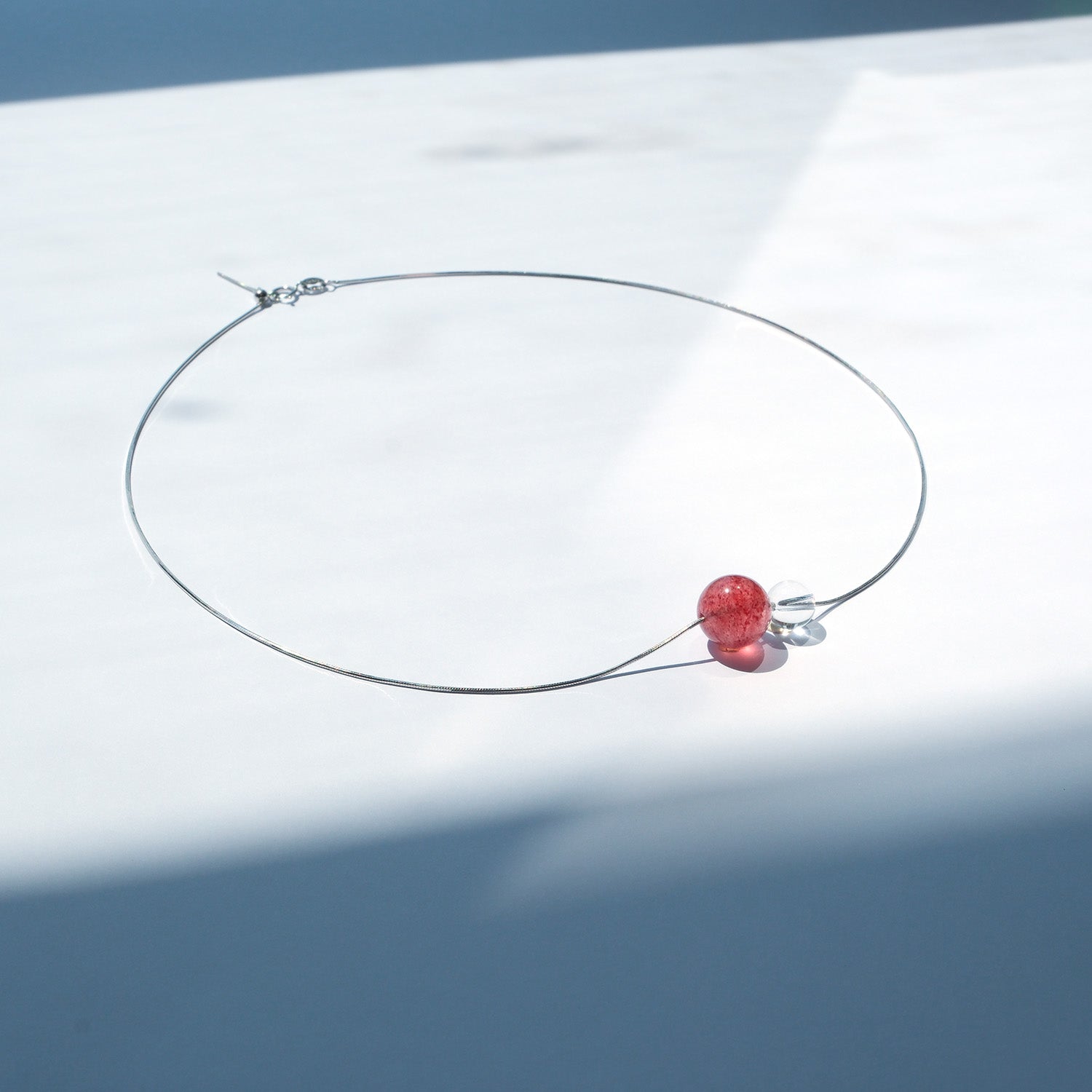 Sterling silver necklace with strawberry quartz and clear quartz beads – vibrant jewellery for positivity and relationships.
