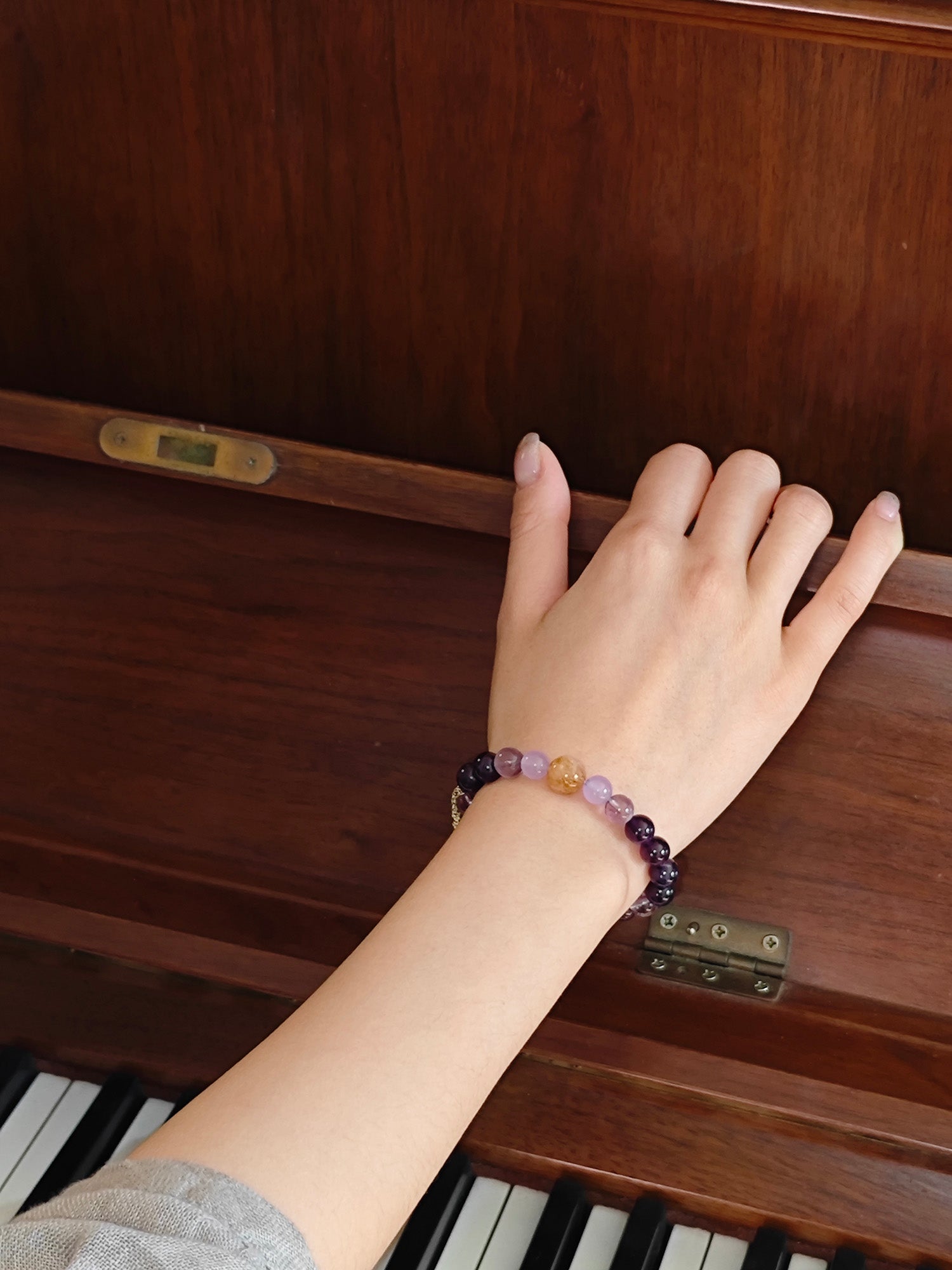 Lifestyle shot of woman with amethyst crystal bracelet for study success