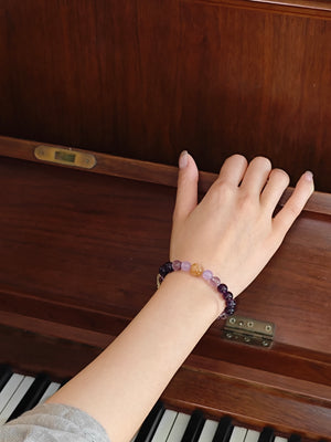 Lifestyle shot of woman with amethyst crystal bracelet for study success