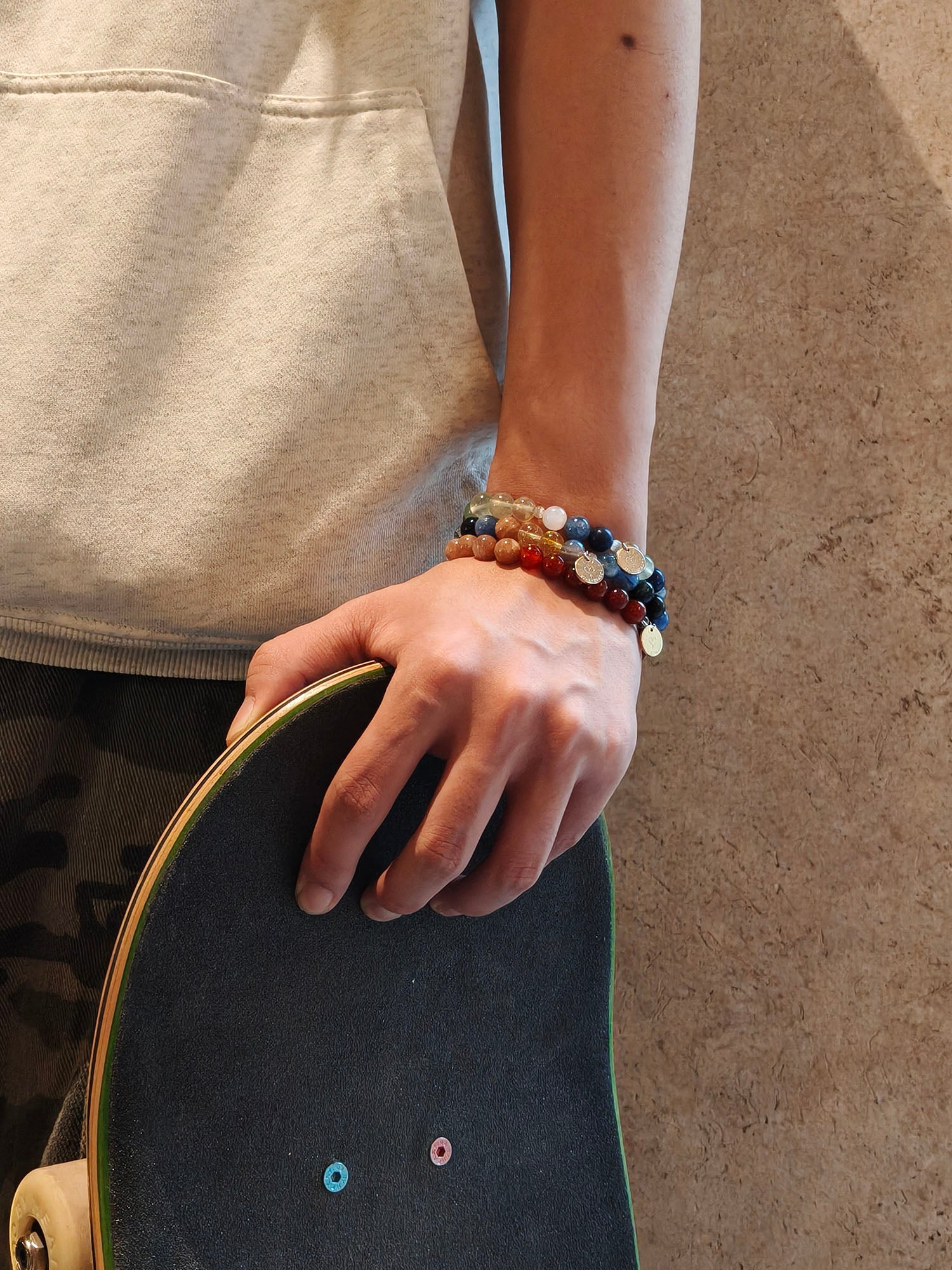 boy wearing natural crystal bracelets in multiple colors for courage and confidence