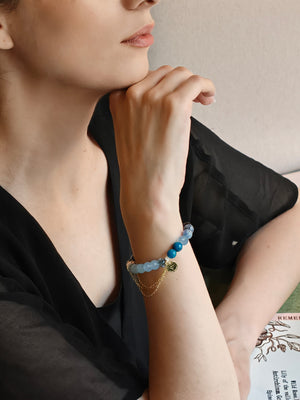Woman wearing kyanite and aquamarine bracelet for career focus