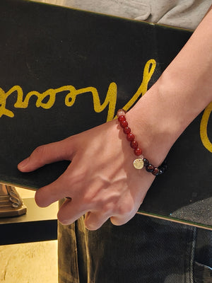 Man wearing red tiger’s eye bracelet for protection and strength