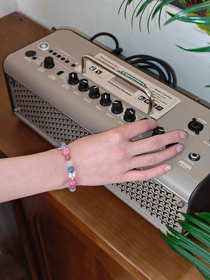Girl wearing rose quartz natural crystal bracelet for party