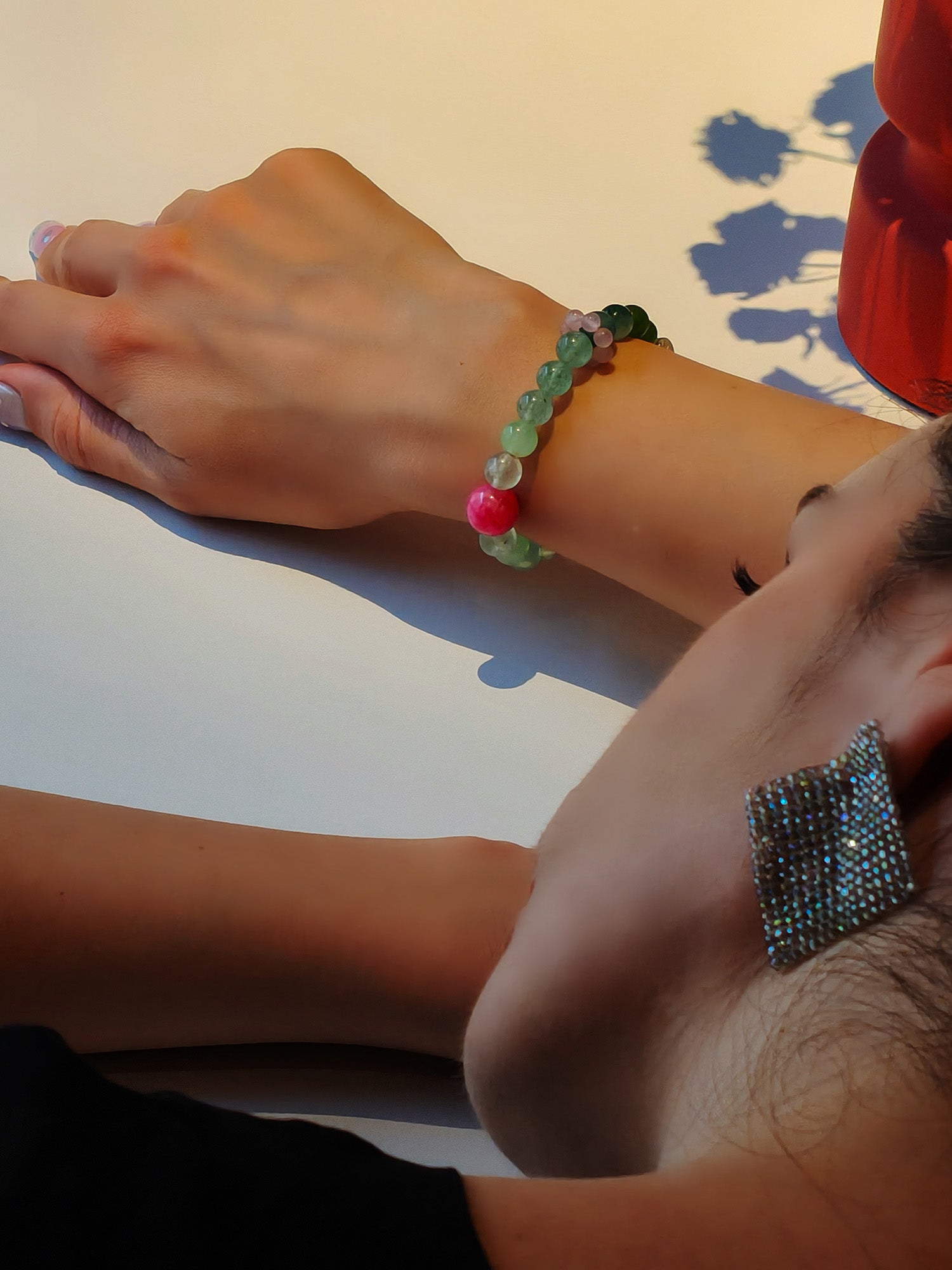 Lifestyle shot of woman with green strawberry quartz bracelet for vitality and fresh ideas