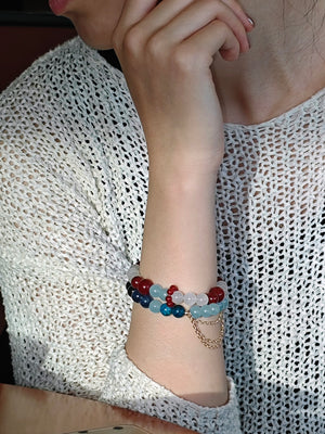 Woman wearing natural crystal bracelet for ambition and courage with agate and aquamarine