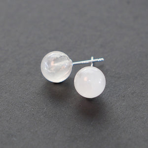 Close-up of clear quartz earrings with sterling silver studs