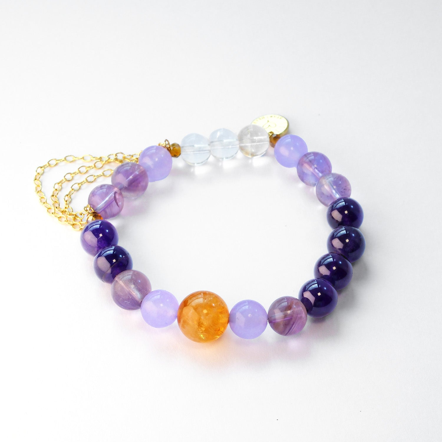 Close-up of amethyst beads with white and yellow azeztulite accents