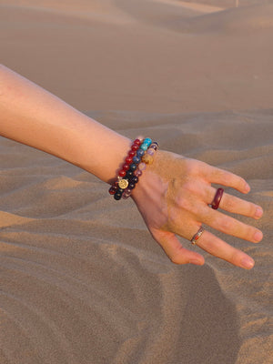 man wearing natural genmstone bracelets