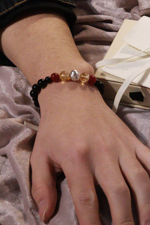 Waxing Crescent crystal bracelet worn on wrist, warm-toned gemstones for everyday confidence